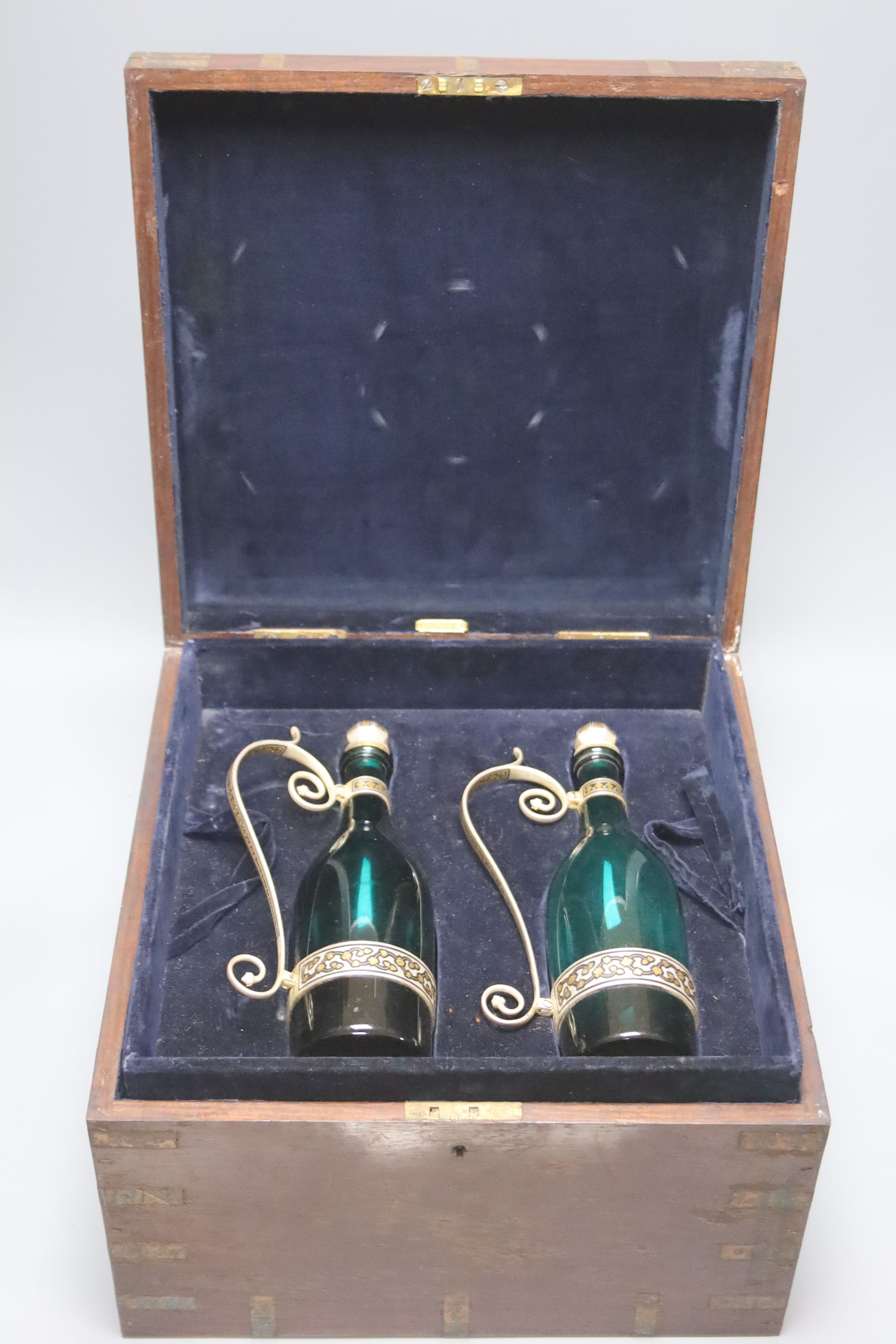 An early 20th century Indian niello and gilt metal liqueur set, with six goblets, pair of decanters and in a hardwood box